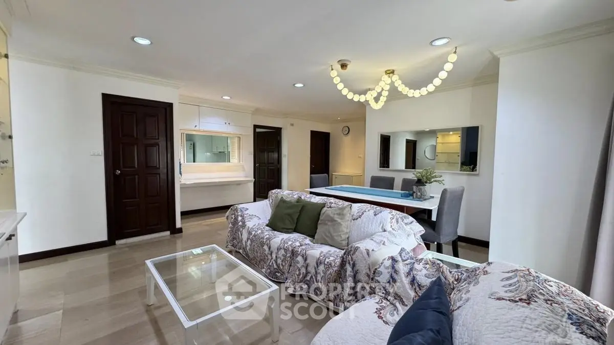 Spacious living room with elegant decor and modern lighting in a luxury apartment.
