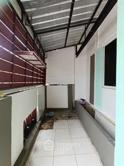 Spacious balcony with tiled flooring and modern design elements
