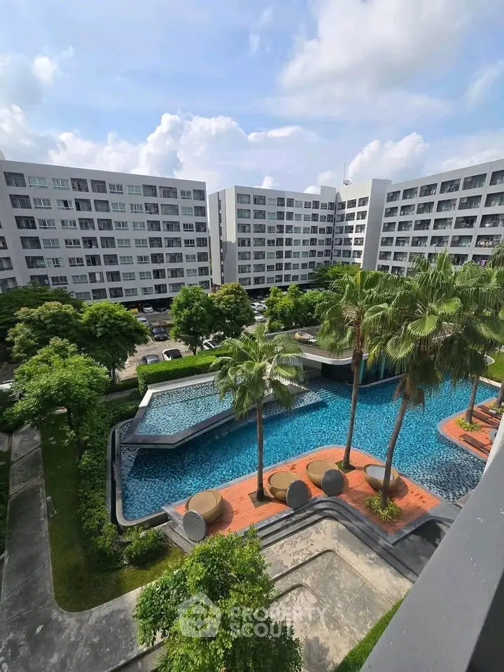 Luxurious residential complex with stunning pool and lush greenery, offering a serene urban oasis.