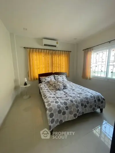 Cozy bedroom with natural light and modern decor, featuring a comfortable bed and stylish curtains.