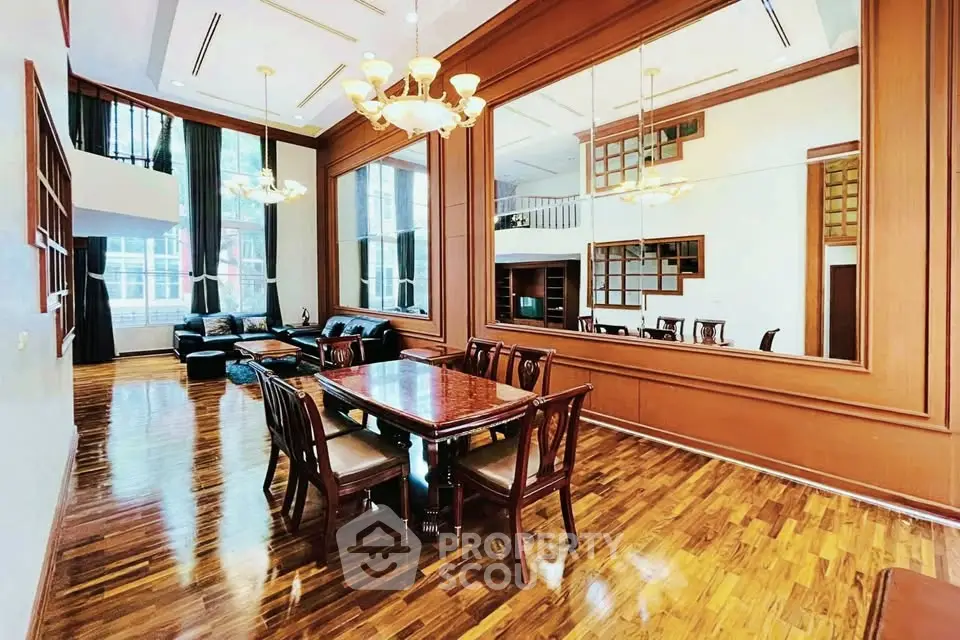 Luxurious dining area with elegant wooden flooring and large mirrors, perfect for entertaining guests.