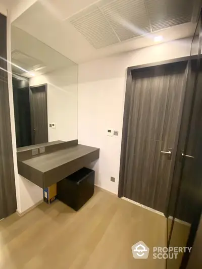 Modern hallway with sleek wooden doors and built-in vanity desk