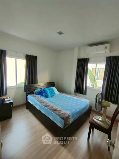 Cozy bedroom with modern furnishings and natural light, perfect for relaxation.