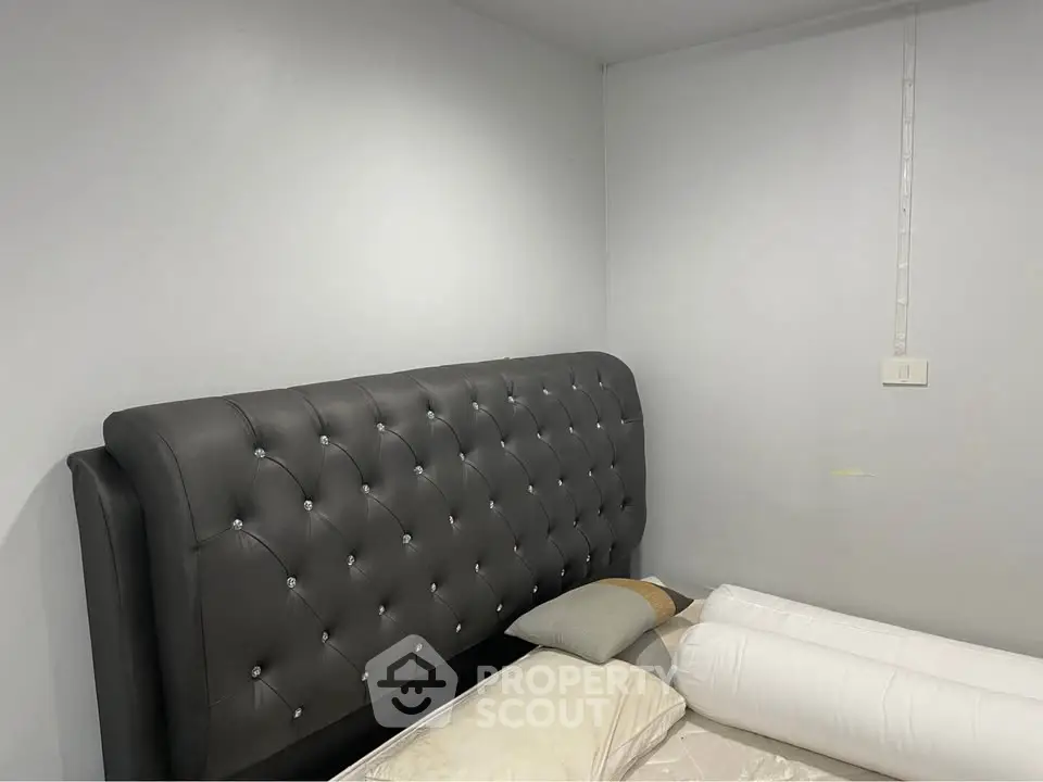 Modern bedroom with stylish tufted headboard and neutral decor