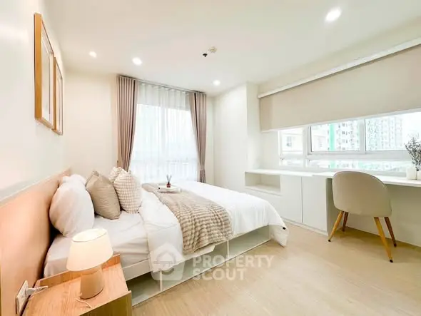 Bright and modern bedroom with large windows and stylish decor in a contemporary apartment.