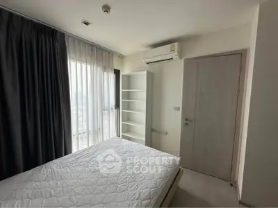 Modern bedroom with natural light, air conditioning, and minimalist decor in a stylish apartment.