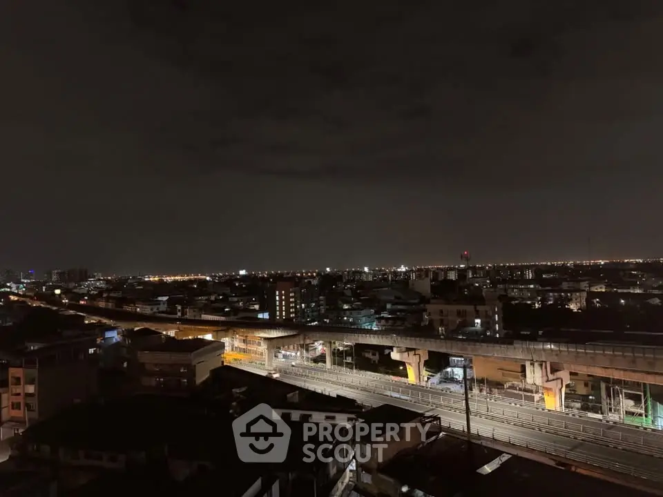 Stunning night cityscape view with illuminated skyline and railway tracks