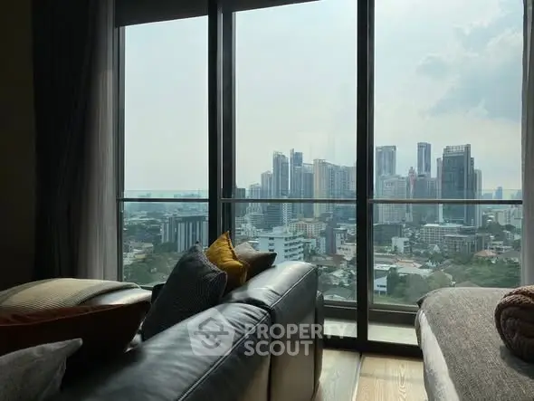 Luxurious living room with stunning city view from high-rise apartment.