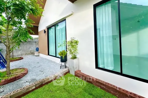 Charming modern home exterior with lush garden and large windows