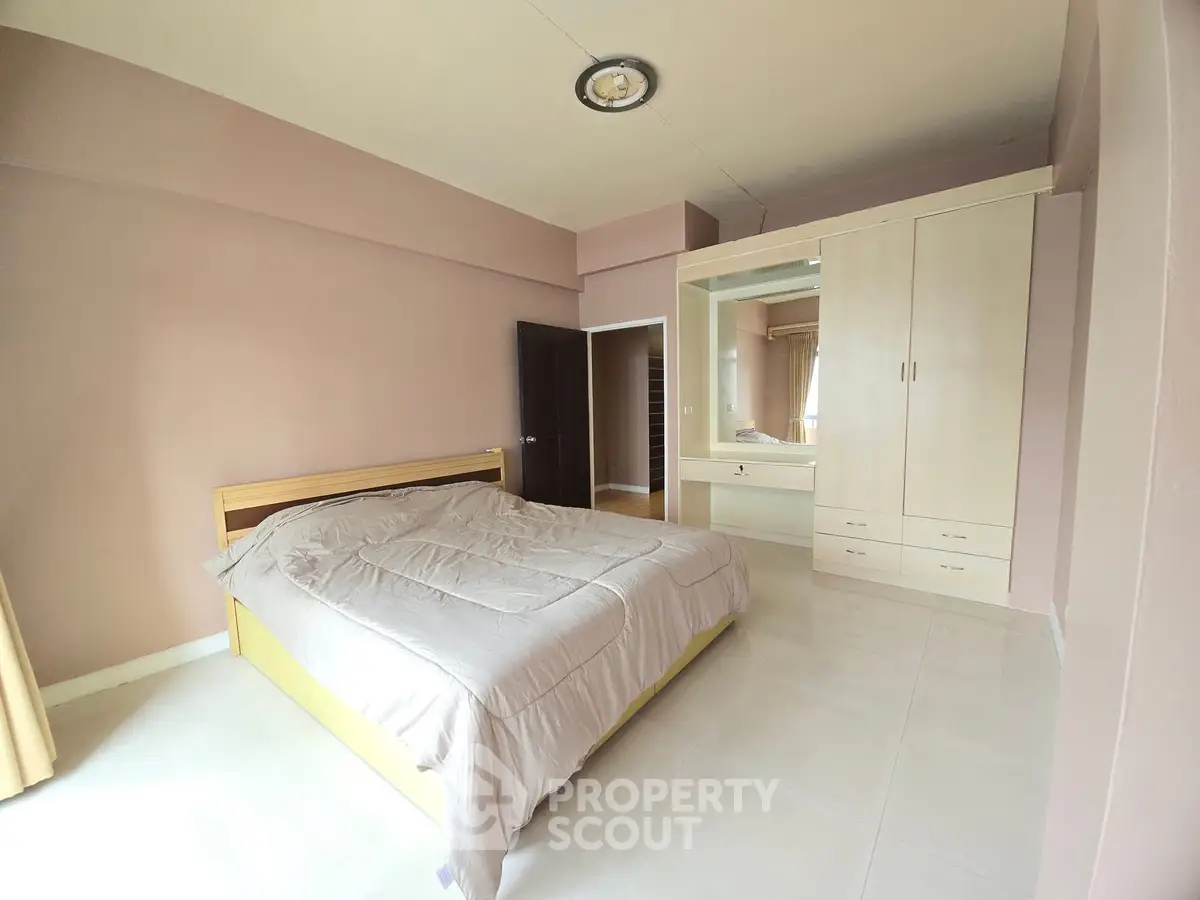 Spacious bedroom with modern furnishings and ample natural light