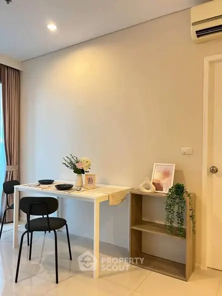 Modern dining area with minimalist decor and air conditioning in a cozy apartment.