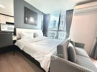 Modern bedroom with city view, featuring elegant decor and ample natural light.
