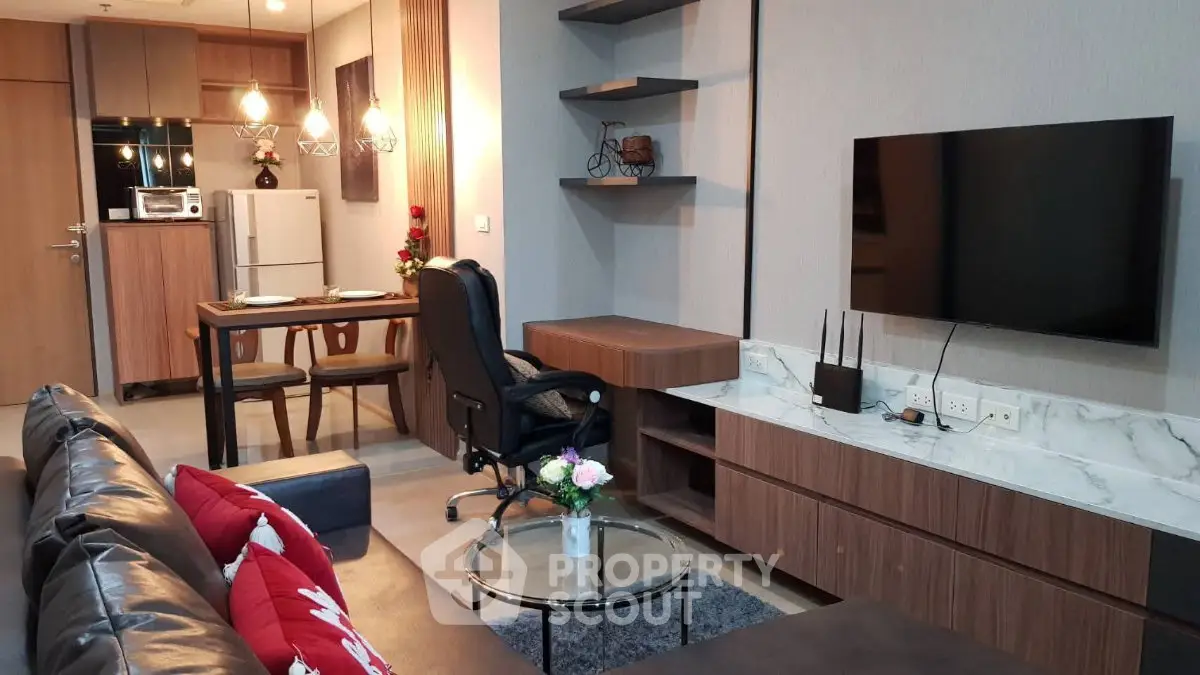 Modern living room with stylish decor, open kitchen, and cozy seating area in a contemporary apartment.