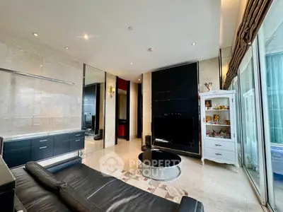 Luxurious living room with modern black leather sofa, sleek TV setup, and elegant decor in a high-end apartment.