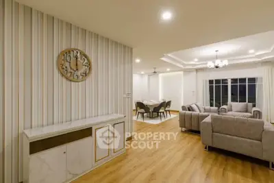 Spacious modern living room with elegant decor and open dining area