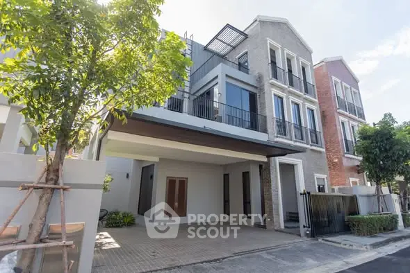 Modern townhouse exterior with spacious driveway and lush greenery