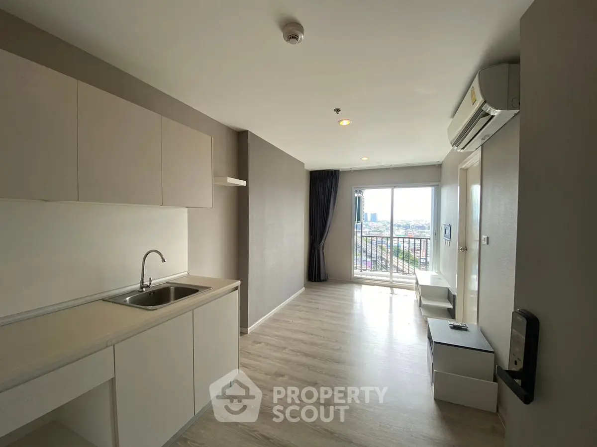 Modern apartment interior with open kitchen and balcony view