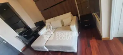 Stylish living room with modern white sofa and wooden flooring