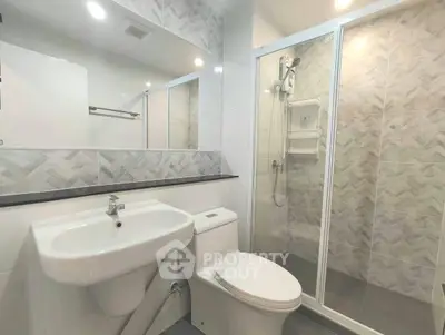 Modern bathroom with sleek fixtures and glass shower enclosure