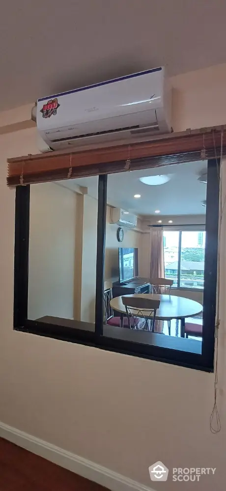 Cozy dining area with air conditioning and large window view