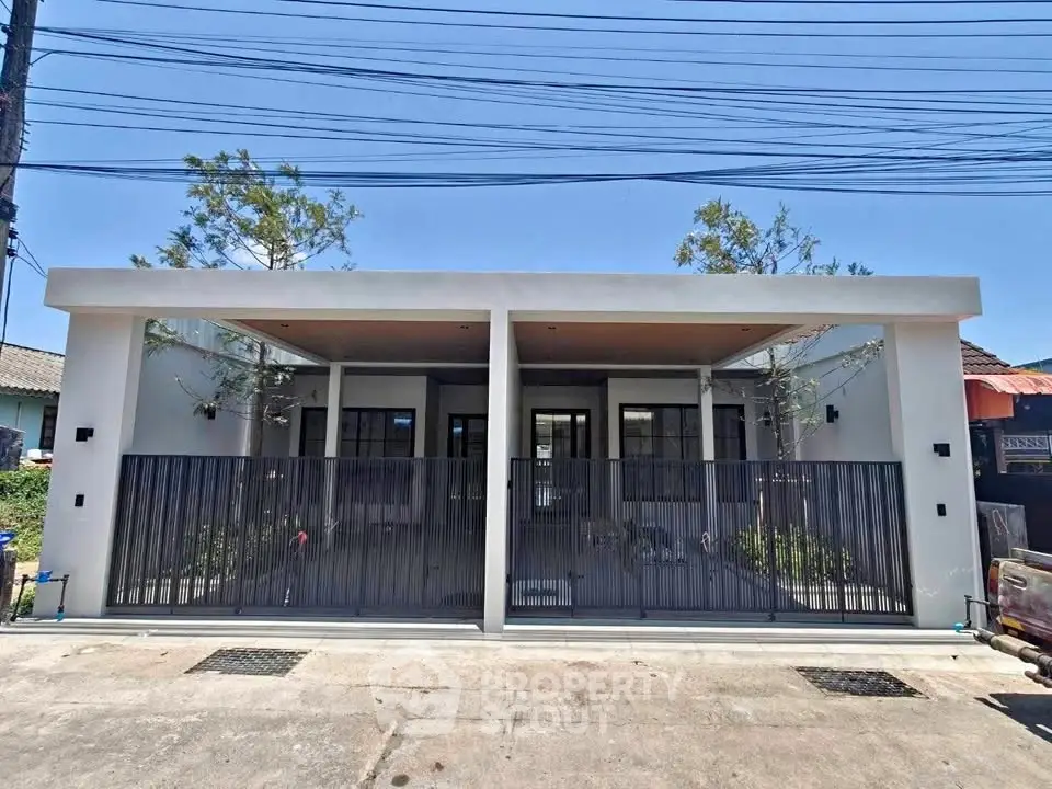 Modern duplex exterior with sleek design and gated entrance in a suburban neighborhood.