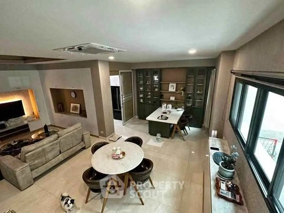 Spacious modern living room with open kitchen and stylish dining area, perfect for entertaining.