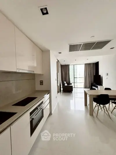 Modern open-plan kitchen and living area with sleek design and natural light.
