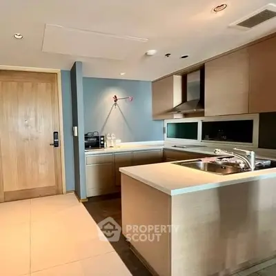 Modern kitchen with sleek cabinetry and island in stylish apartment