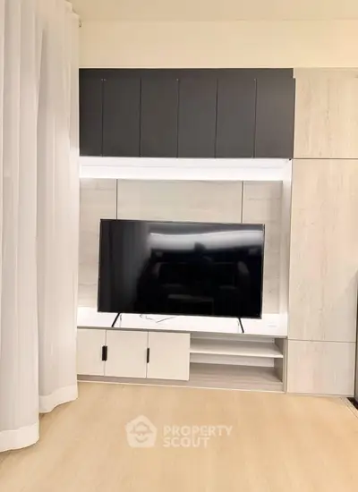 Modern living room with sleek TV setup and stylish cabinetry