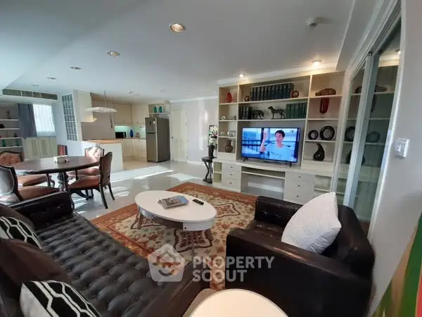 Spacious living room with modern decor and open kitchen layout