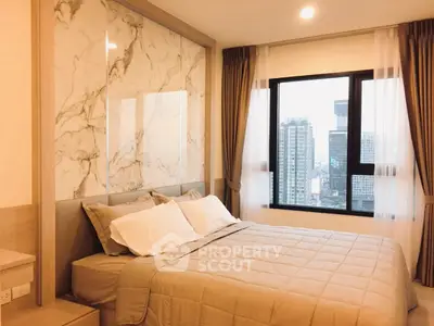 Luxurious bedroom with stunning city view and elegant marble accent wall