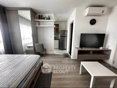 Modern studio apartment with open layout, featuring a cozy living area, sleek kitchen, and stylish decor.