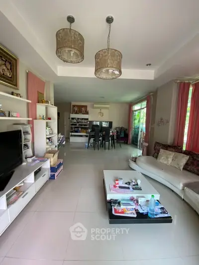 Spacious living room with modern decor and large windows for natural light.
