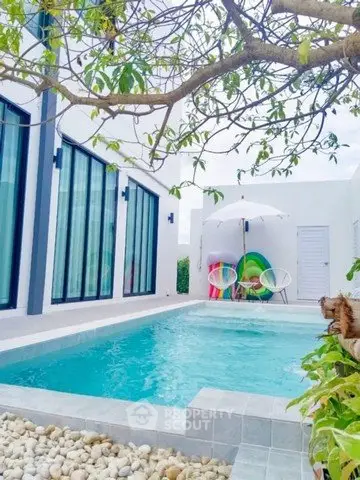 Luxurious modern villa with private pool and stylish outdoor seating area.