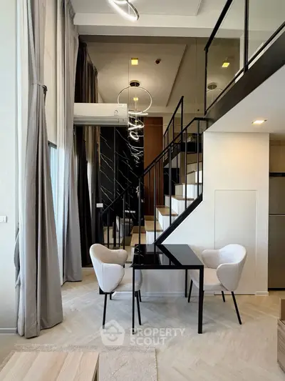 Modern loft apartment with stylish staircase and elegant dining area