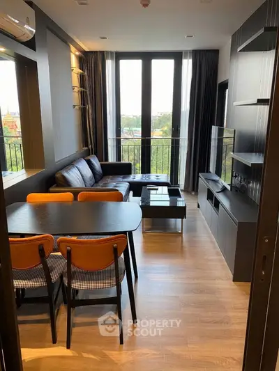 Modern living room with sleek furniture and large windows offering a scenic view.