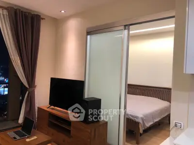 Modern apartment interior with cozy living room and bedroom, featuring wooden furniture and large window view.