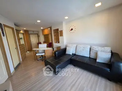 Modern living room with stylish furniture and open layout, featuring a cozy sectional sofa and elegant decor.