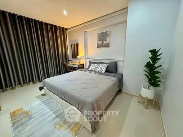 Modern bedroom with stylish decor and cozy ambiance, featuring a comfortable bed and elegant furnishings.