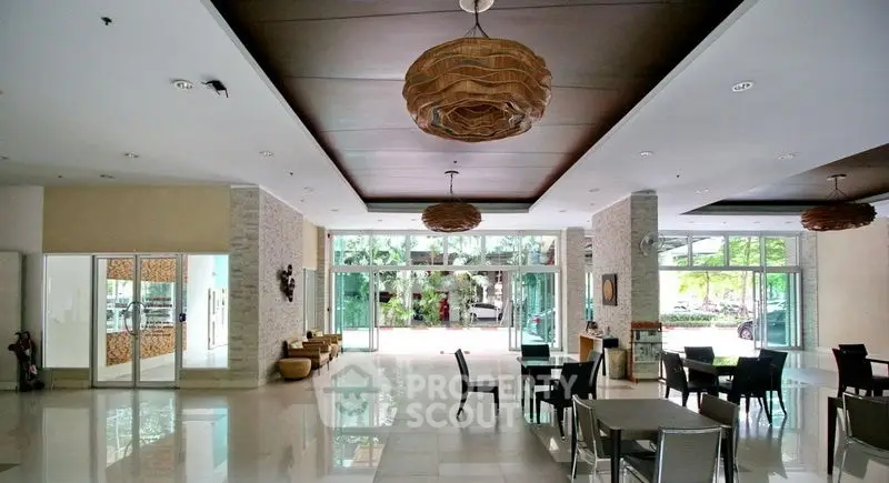 Spacious modern lobby with stylish lighting and garden view