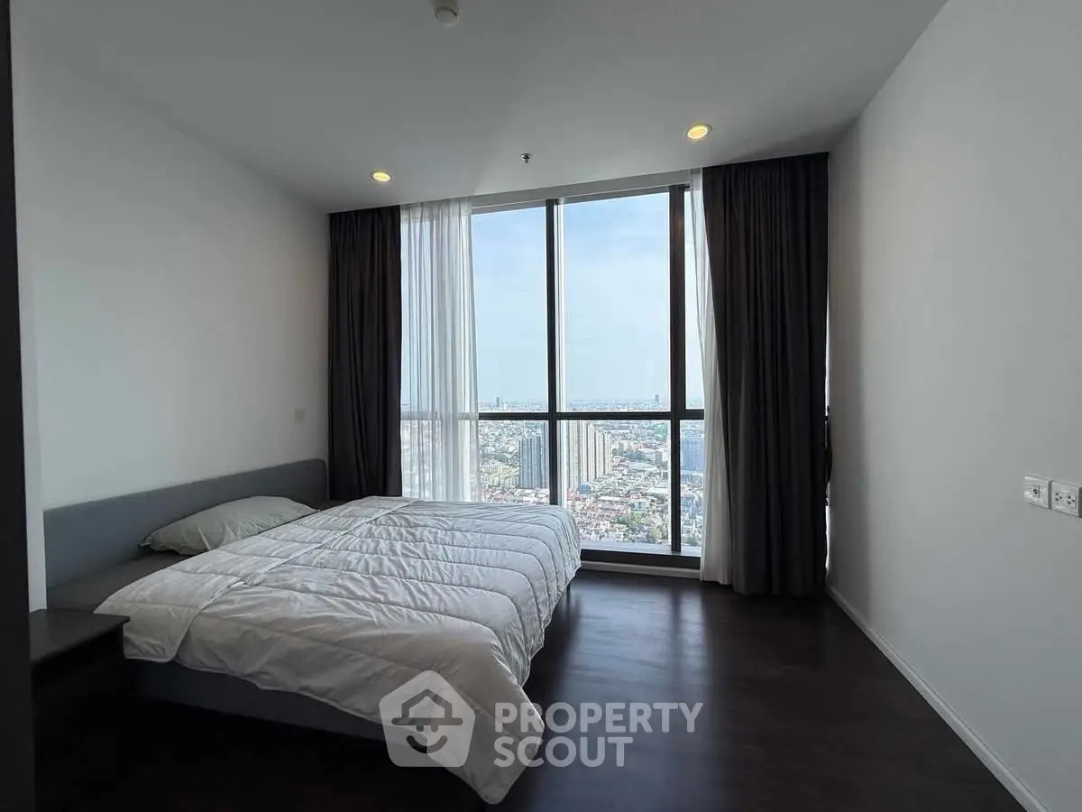 Spacious bedroom with stunning city view and modern minimalist design
