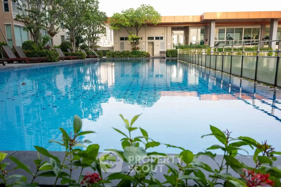 Luxurious residential pool with lush greenery and modern architecture