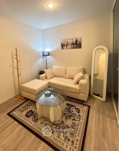 Cozy living room with modern decor, white sofa, stylish rug, and elegant floor lamp.