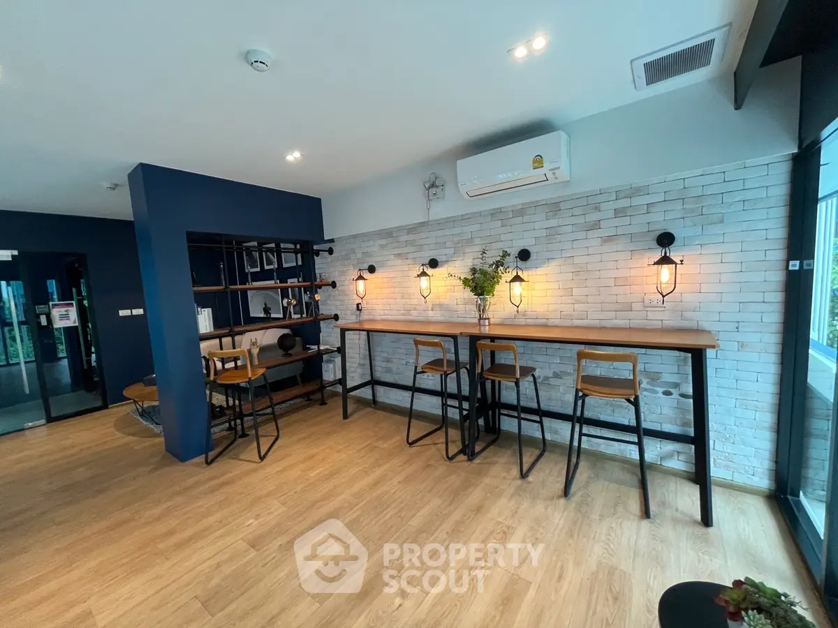 Modern co-working space with stylish bar seating and exposed brick wall