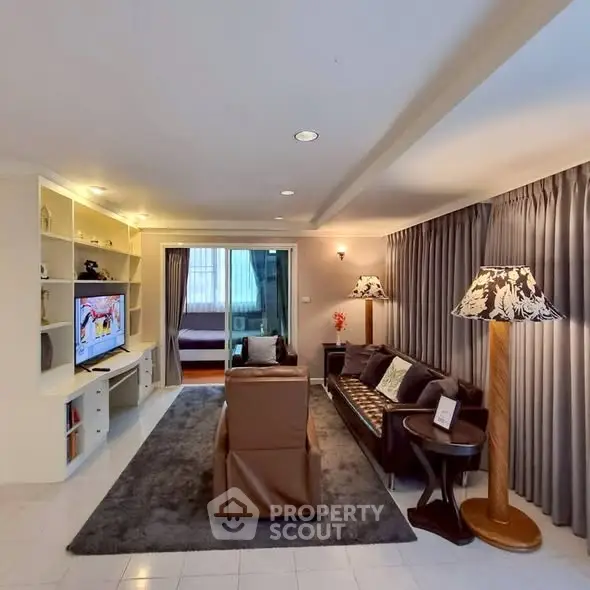 Spacious living room with elegant decor and cozy seating area, perfect for relaxation and entertainment.