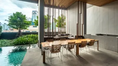 Luxurious outdoor dining area with pool and city view, perfect for entertaining.