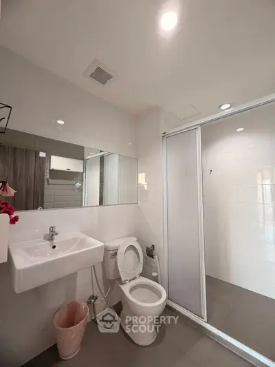 Modern bathroom with sleek fixtures and glass shower enclosure