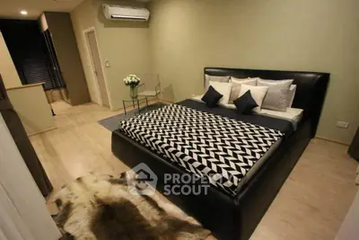 Luxurious bedroom with modern decor and stylish furnishings, featuring a plush bed and elegant accents.