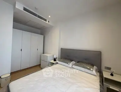 Modern bedroom with sleek design and ample storage in a contemporary apartment.