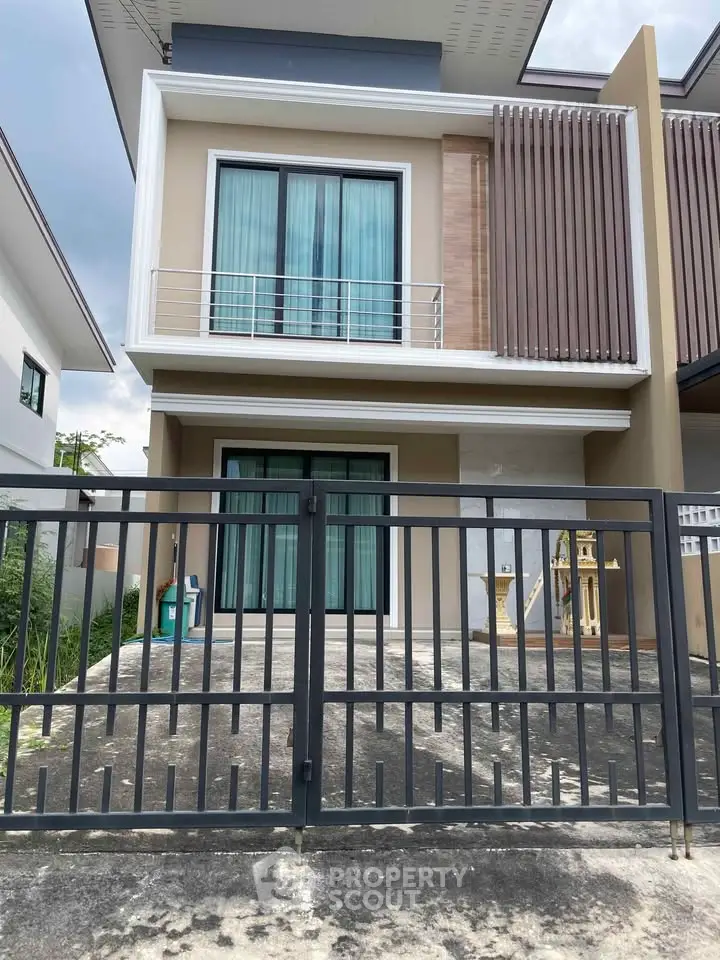 Modern two-story house with sleek design and gated entrance